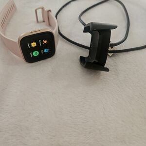 Fitbit Smartwatch with Pink Band and Black Charger